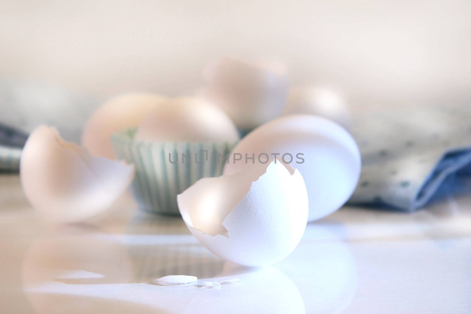 Cracked egg shell on the counter by Sandralise