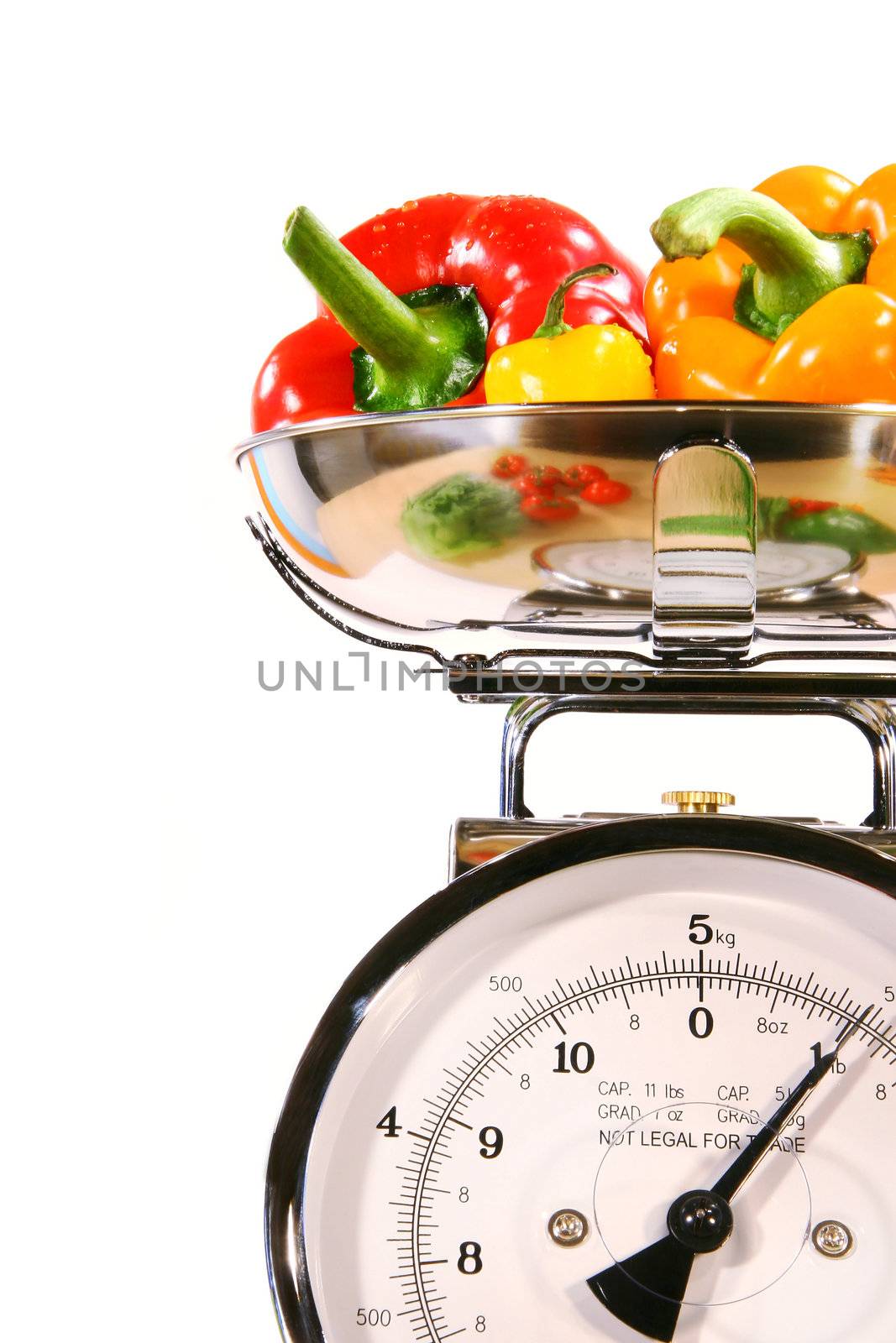 Closeup of kitchen scale with colored peppers by Sandralise