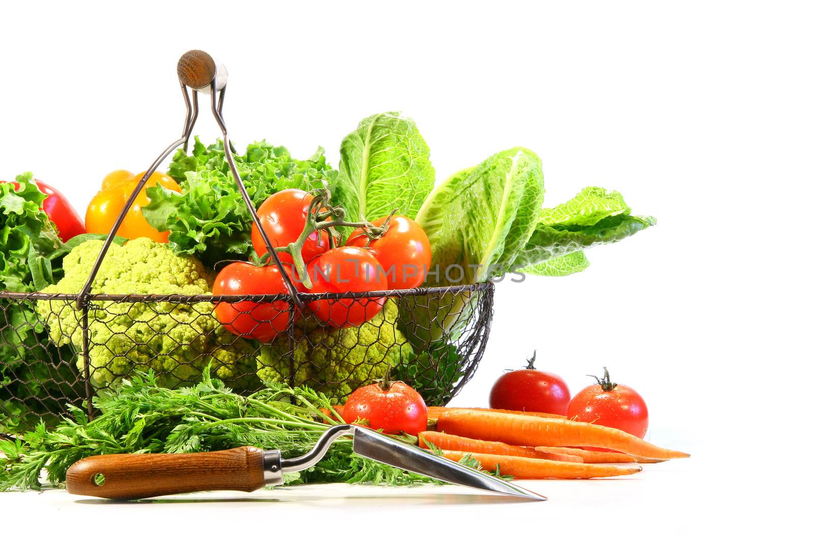 Summer vegetables with garden shovel on white background