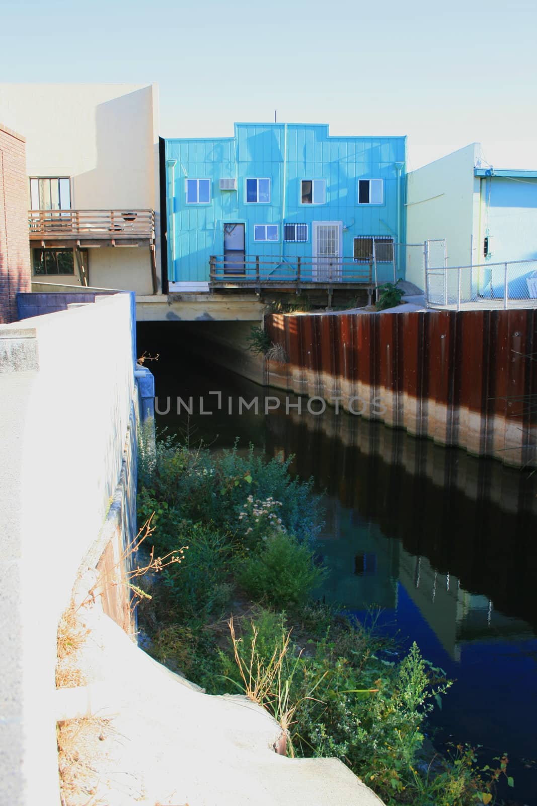 River canal under the buildings of a city.
