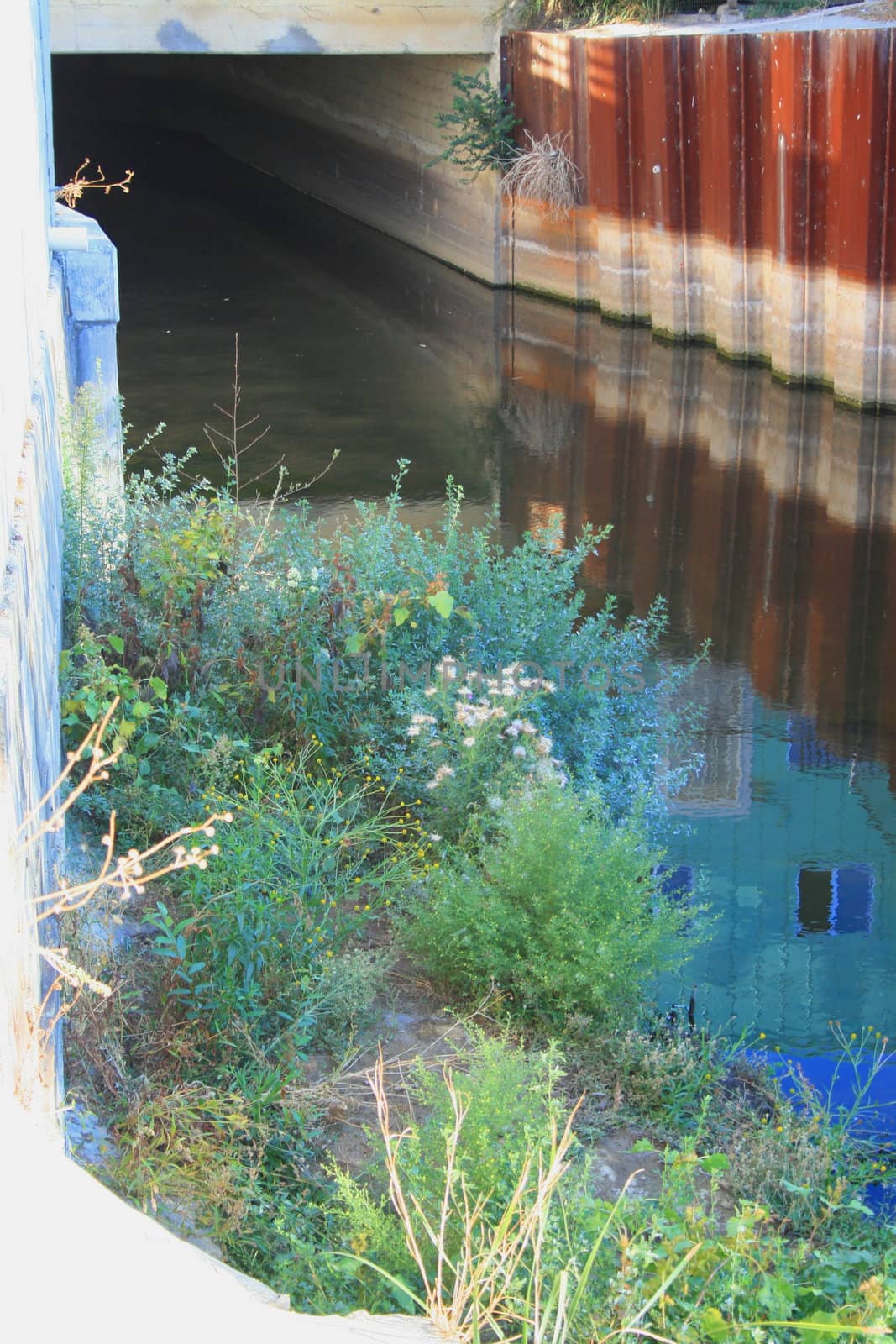 River canal under the buildings of a city.
