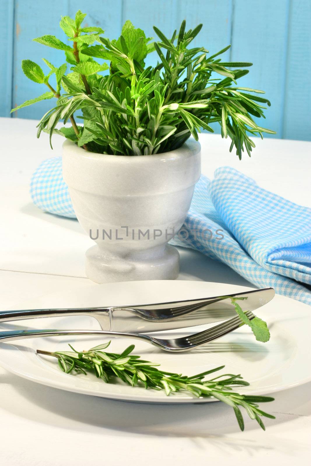 Fresh green herbs on a table by Sandralise
