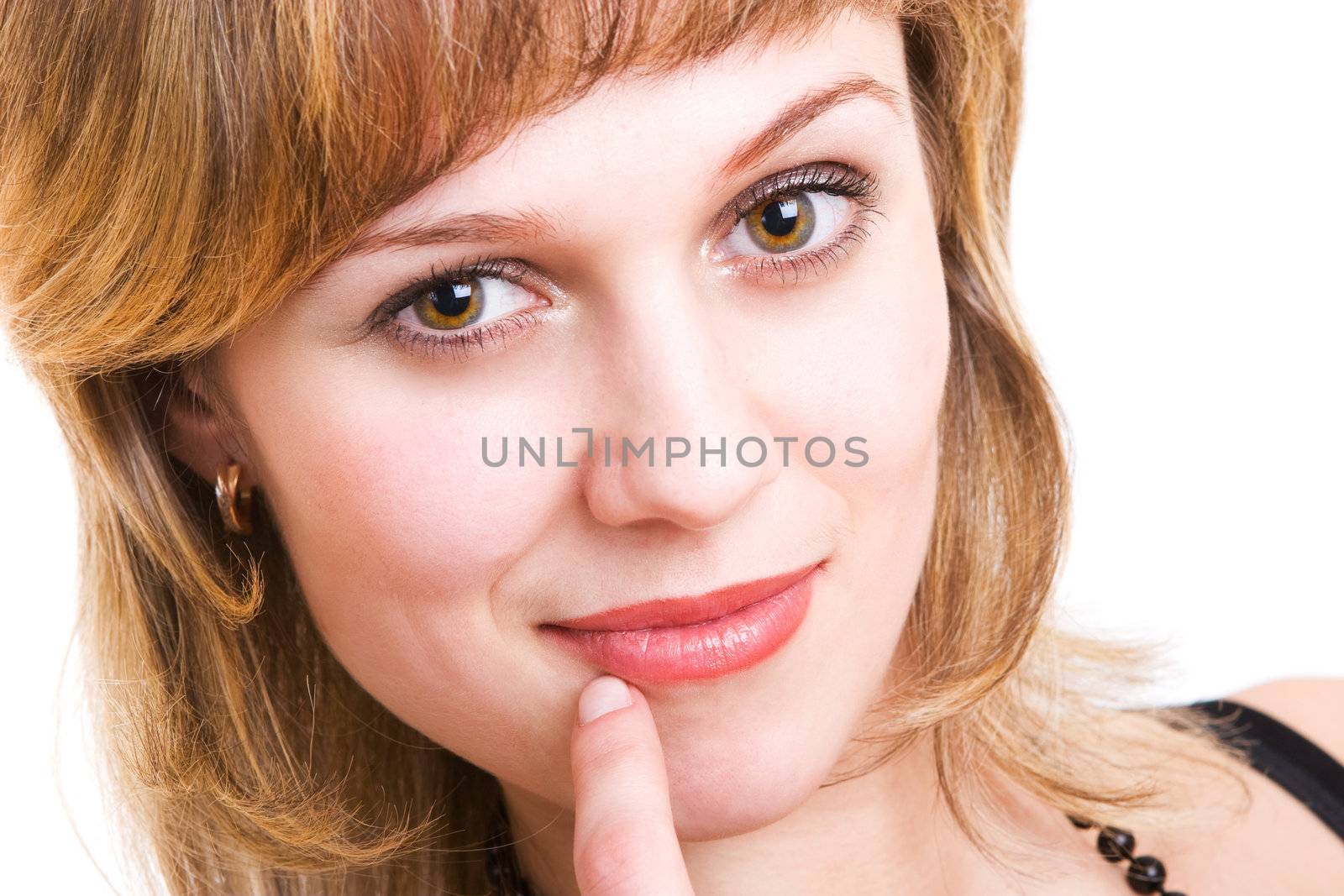 a beautiful girl smiles and holds a finger near her mouth