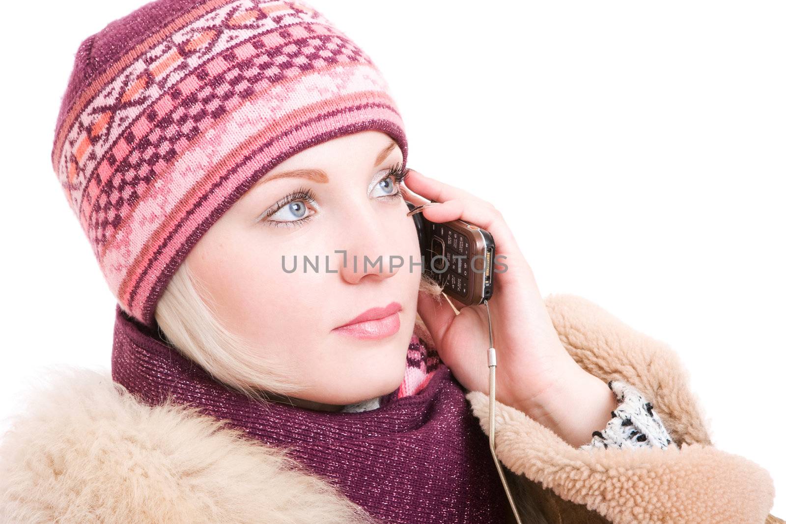 Woman dressed in winter clothes with a mobile phone in hands