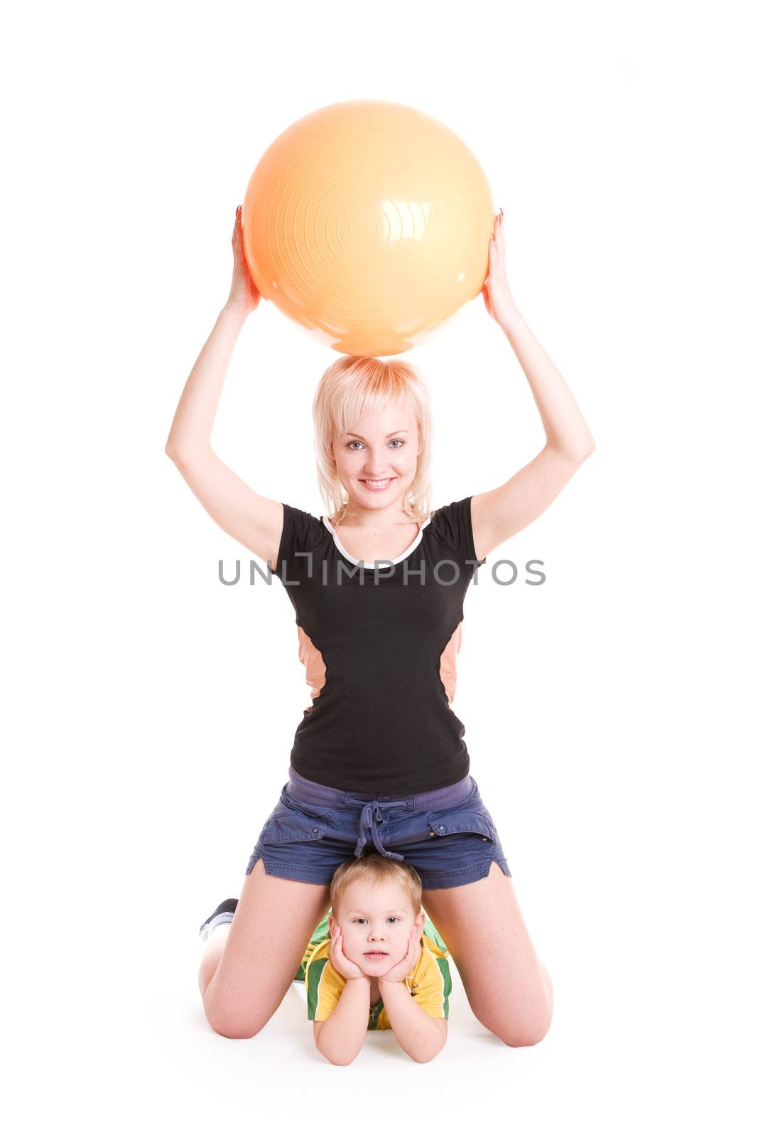young mother with a big ball and a small son do morning exercises