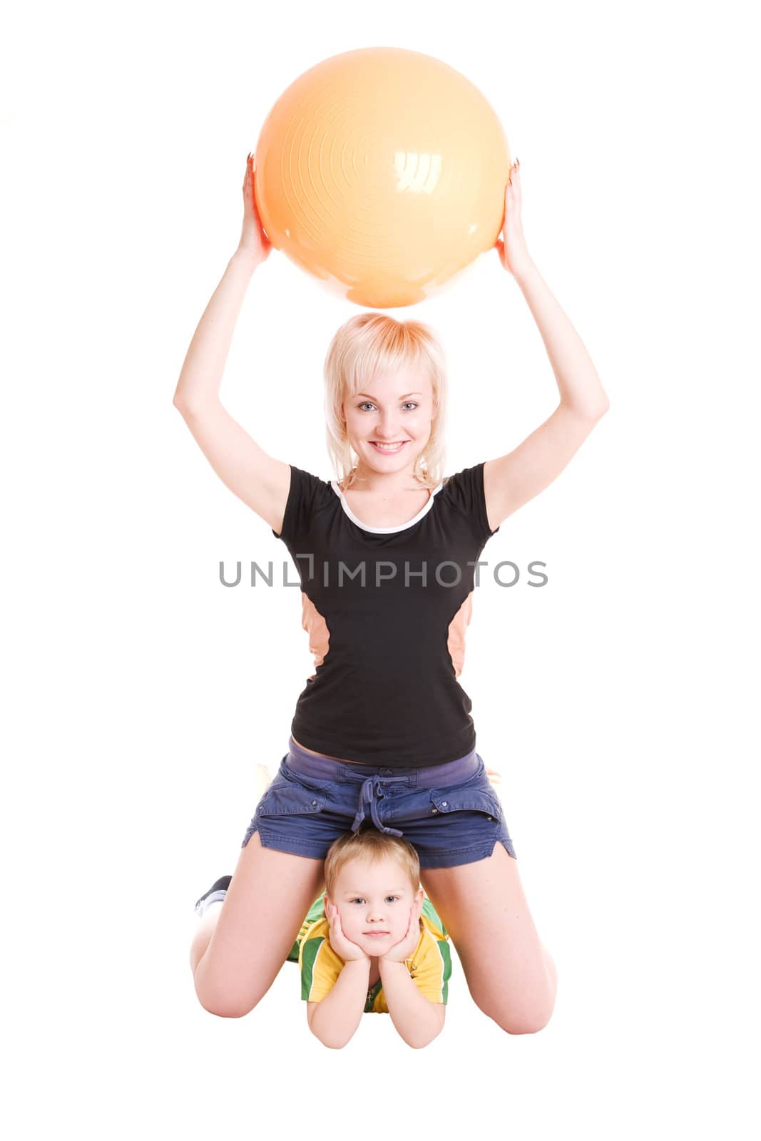 smiling young mother and her son with a fitness ball on the floo by vsurkov