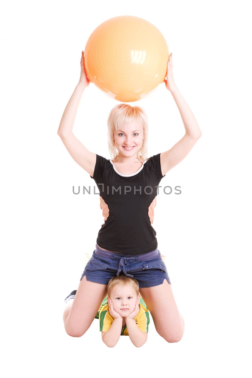 smiling happy young mother and her son with a fitness ball on the floor