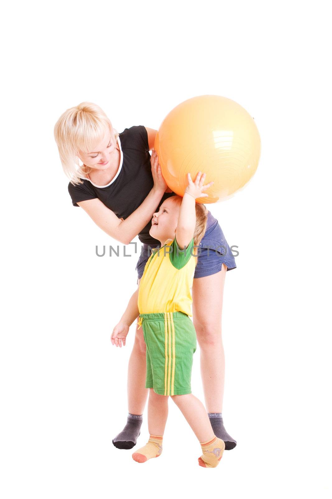 mother and her son with a fitness ball in their hands by vsurkov