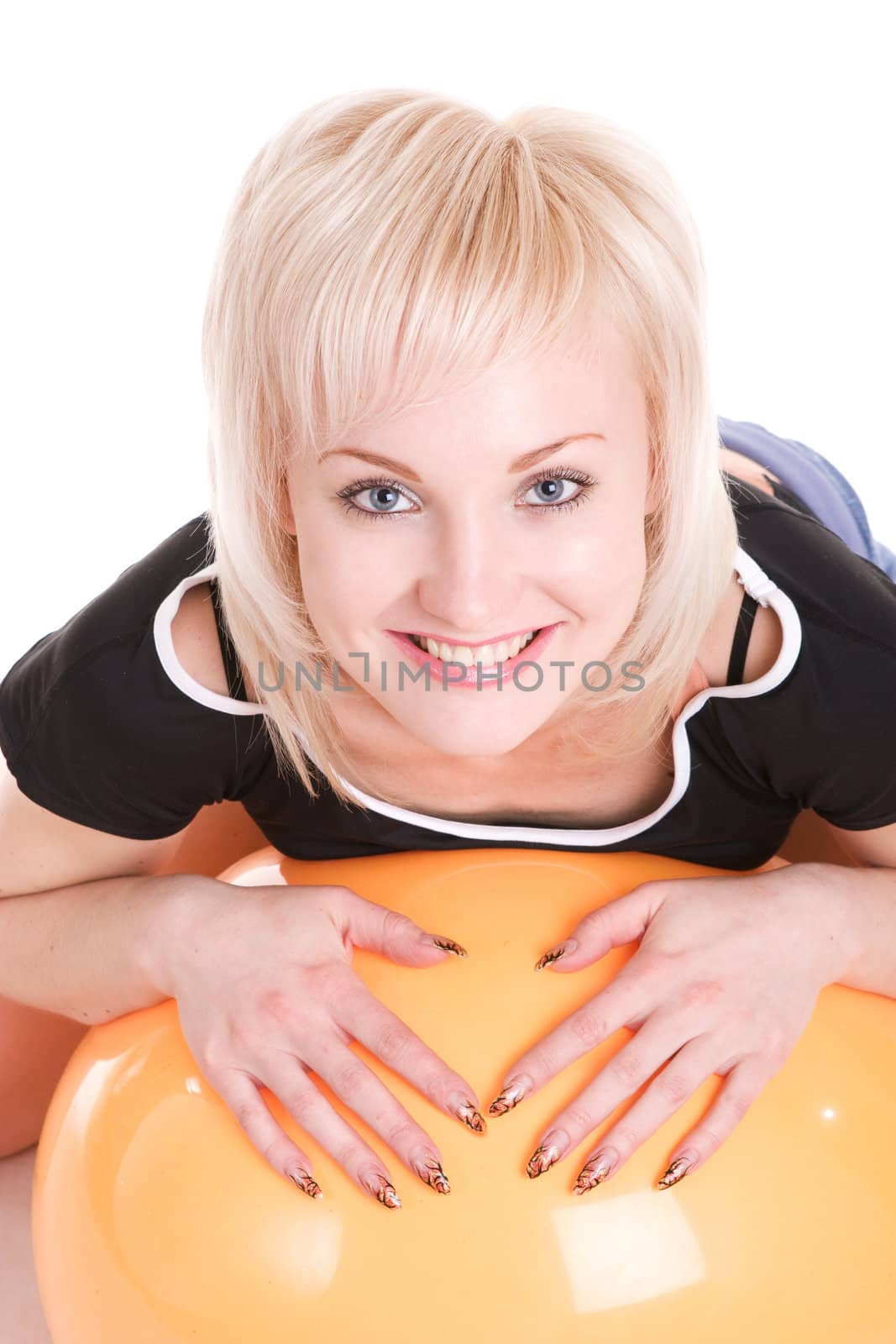 happy blond girl lays on the big ball