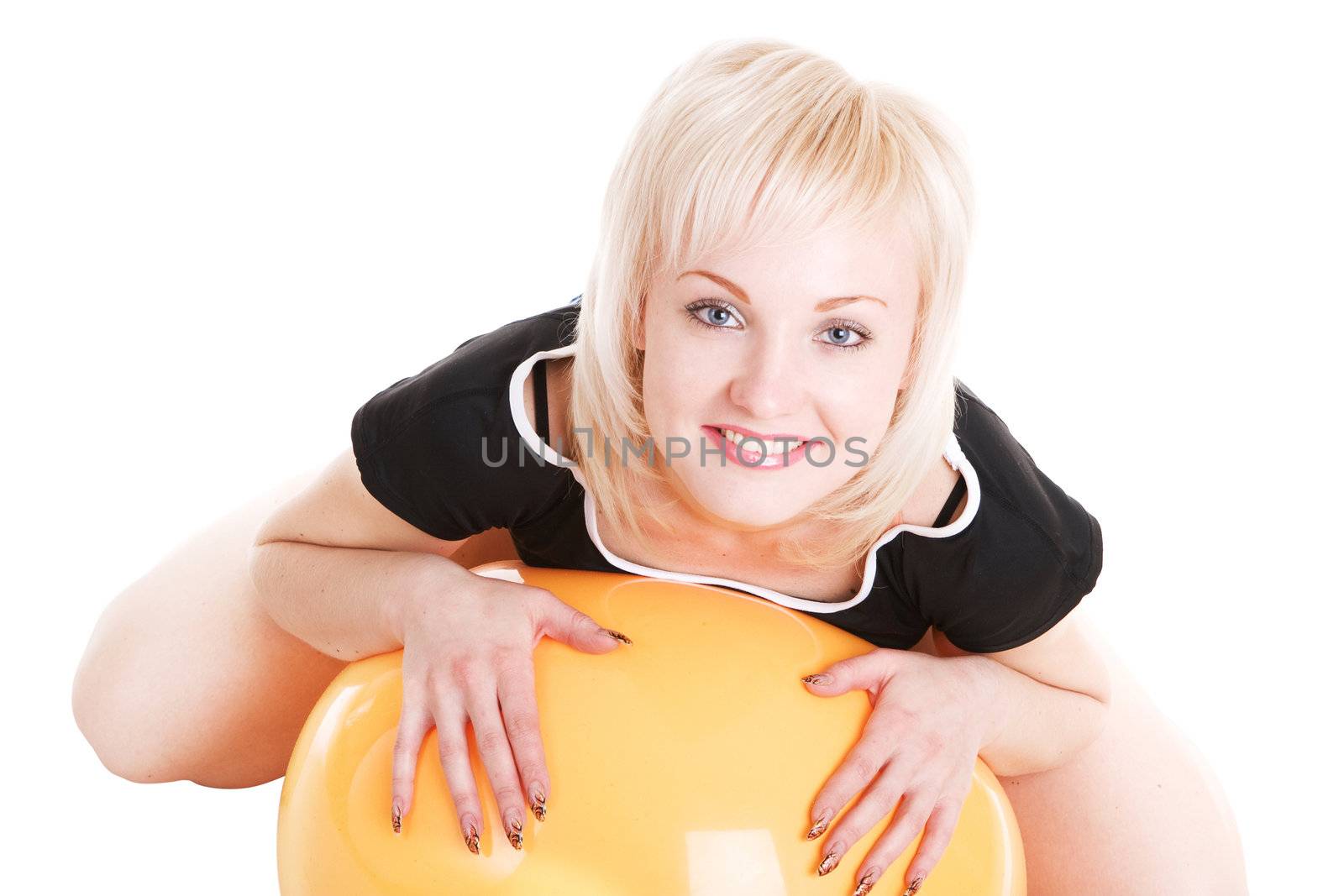 a smiling sexy blond girl with a fitness ball on the floor