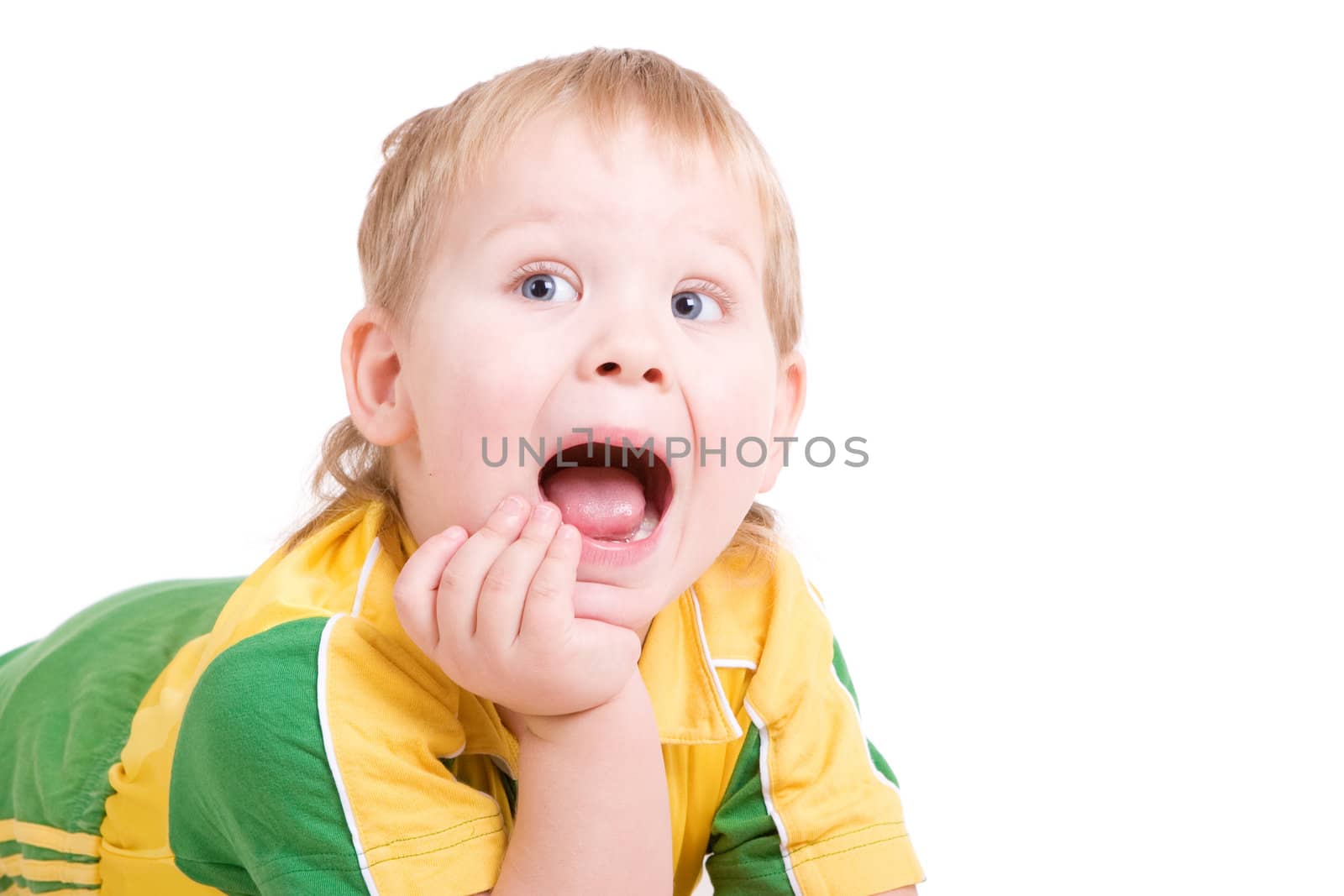 a shouting boy lays on the floor with the open mouth