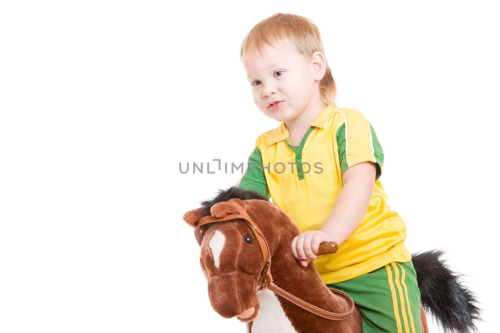 a boy of three years old riding a toy horse