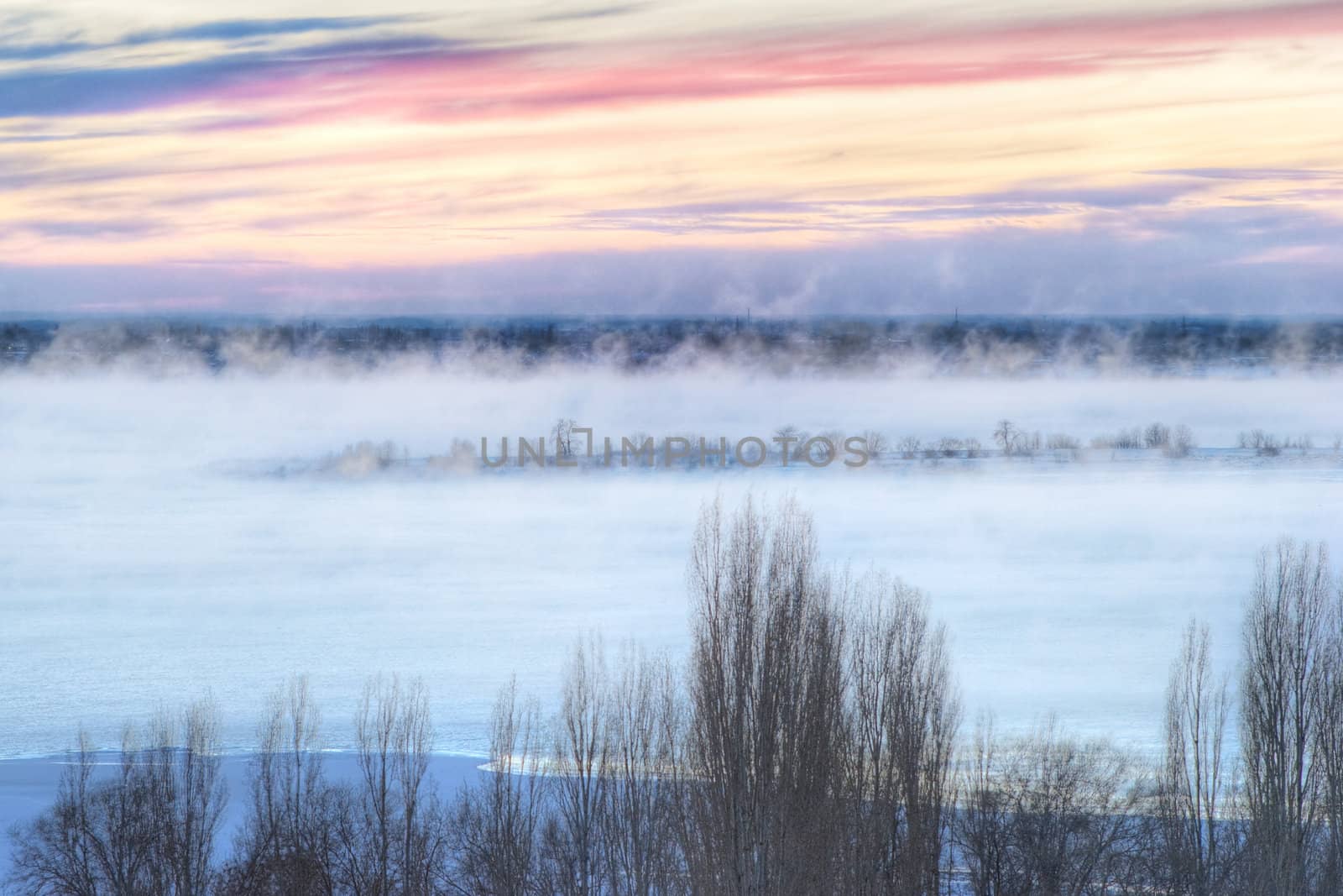frozen sunrise over the river in fog