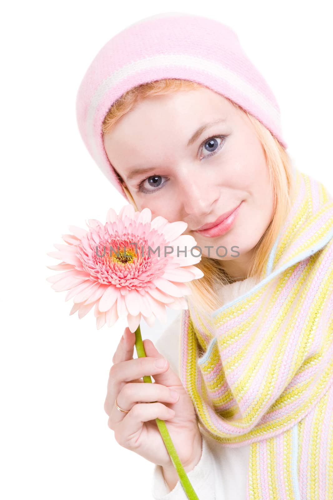 The pretty woman with a pink flower in hands
