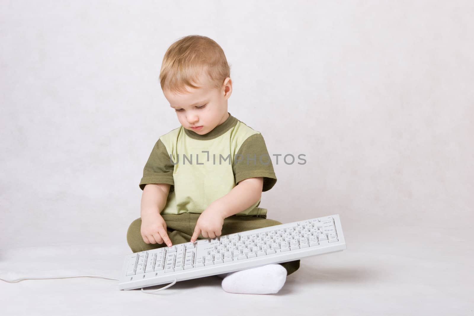 little boy typing on keyboard