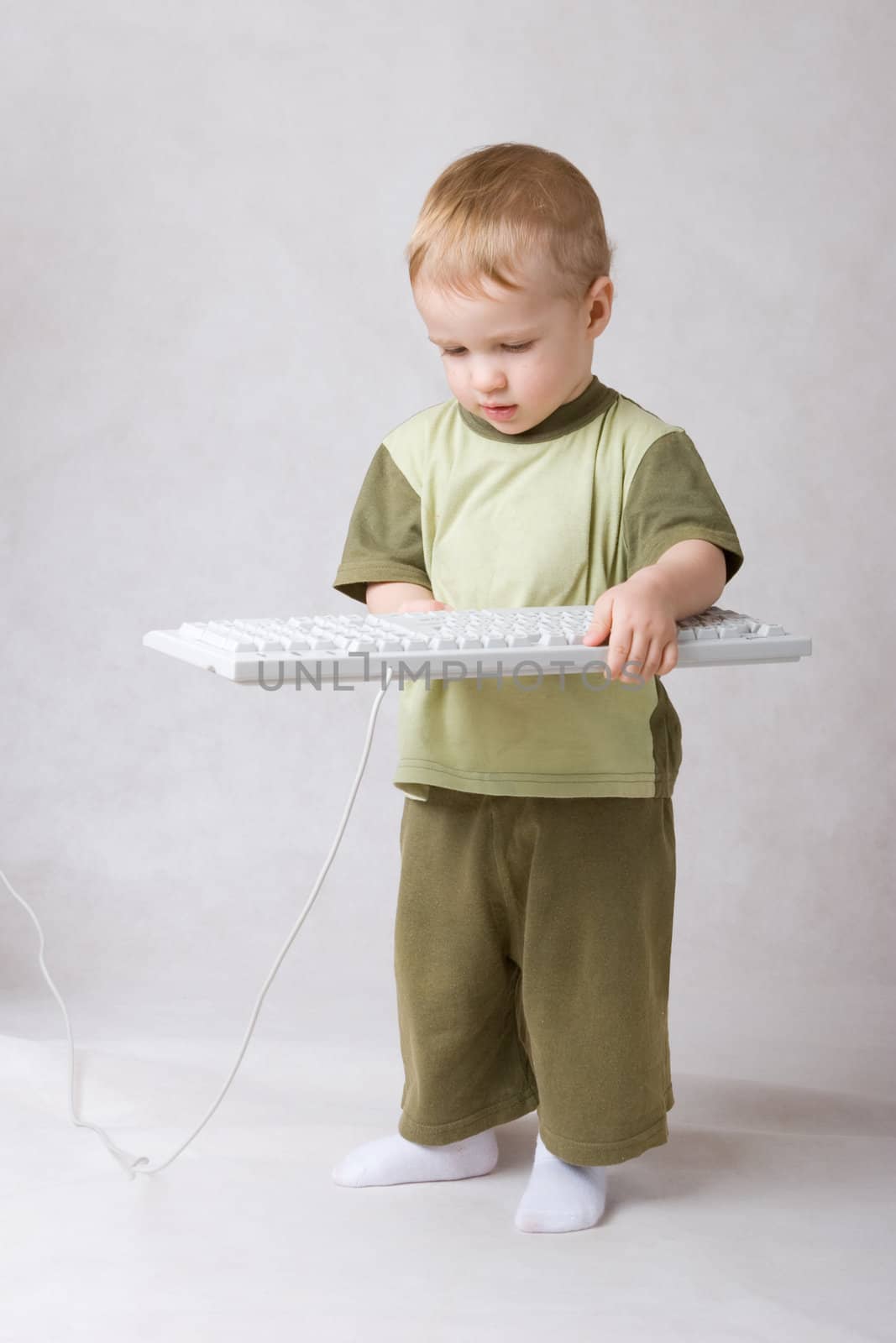 small boy with a keyboard in hands