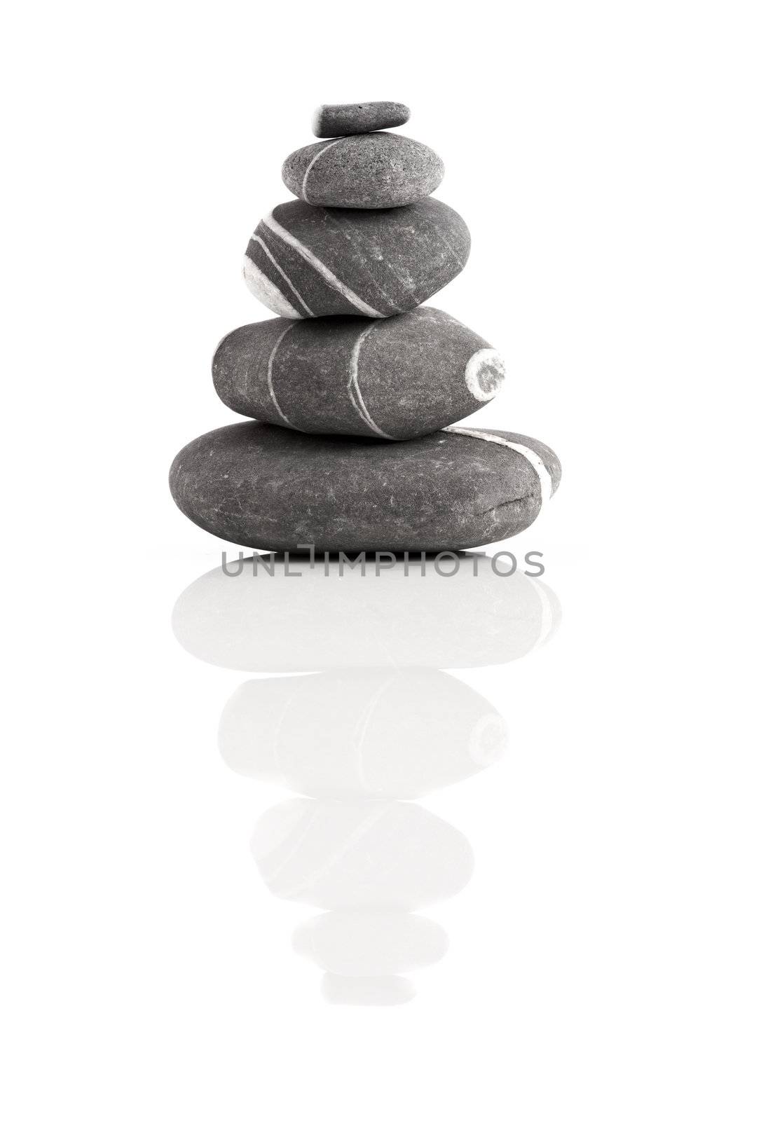 Stones pyramid isolated on white background with reflection