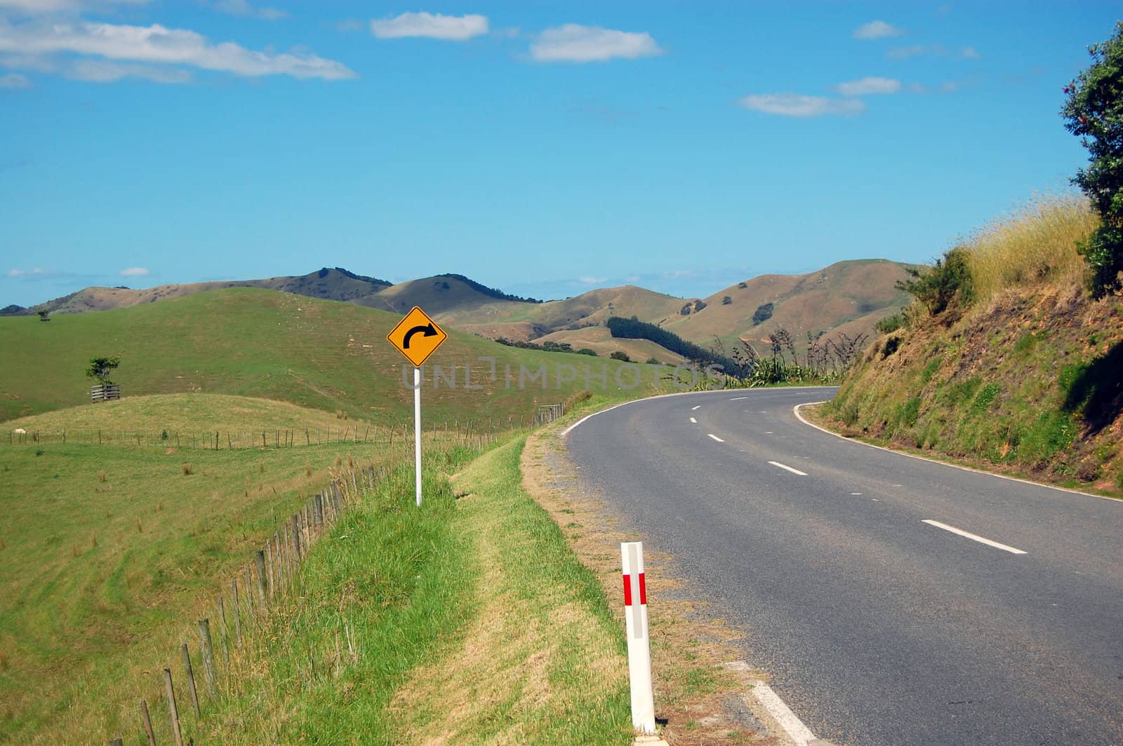 Yellow arrow road sign turn right, Waiheke Island, New Zealand