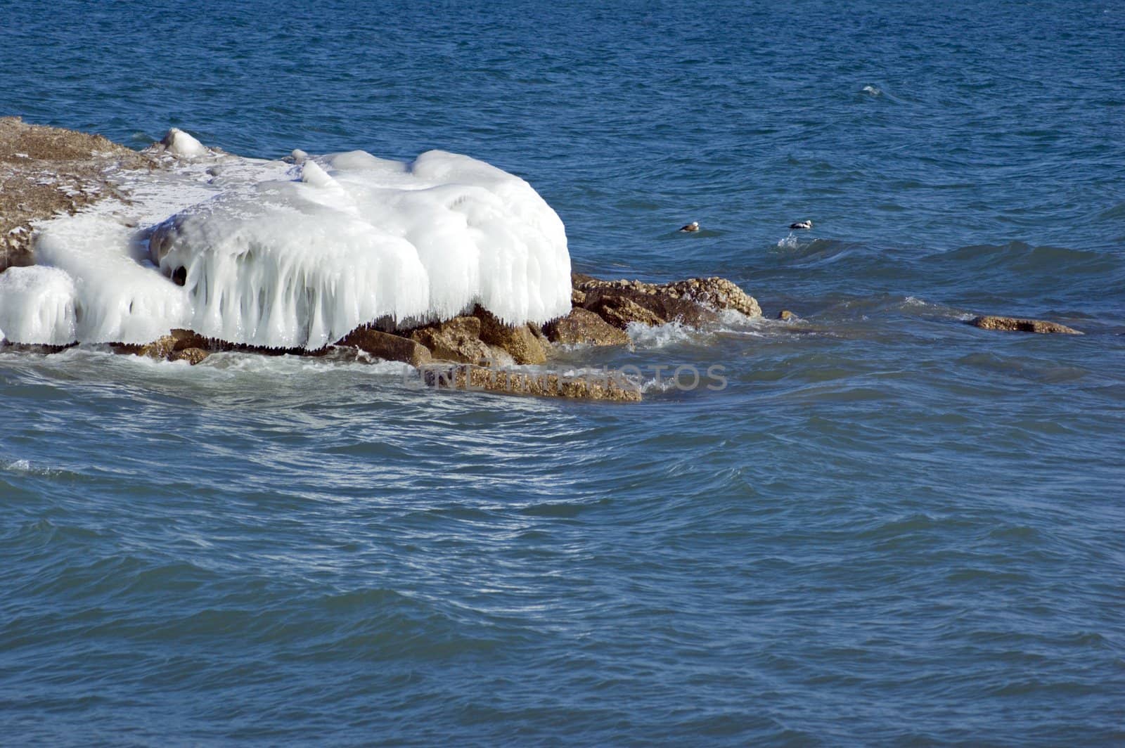 Ice island in Ontario lake in winter evening.