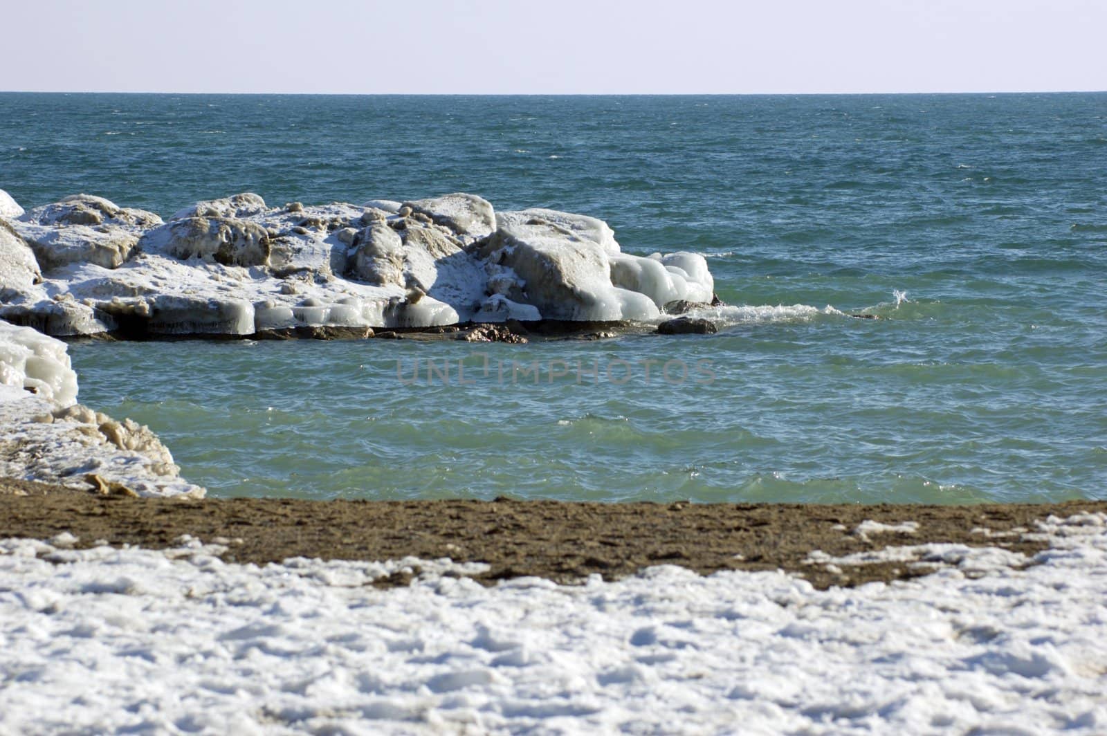 Ice island in Ontario lake in winter evening.