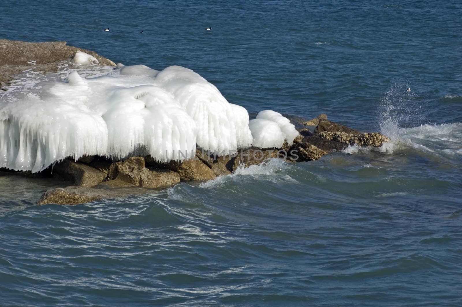 Ice island in Ontario lake in winter evening.