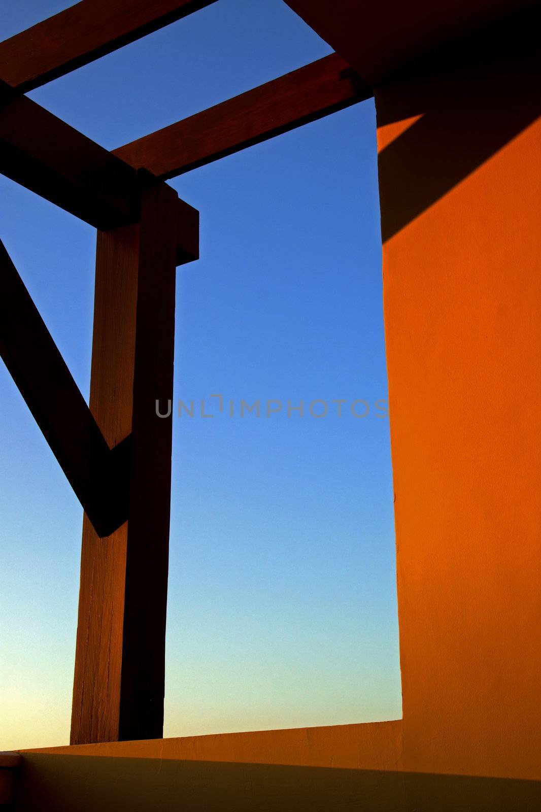 Sunset shadow and warm beams with orange glow on  a tropical balcony