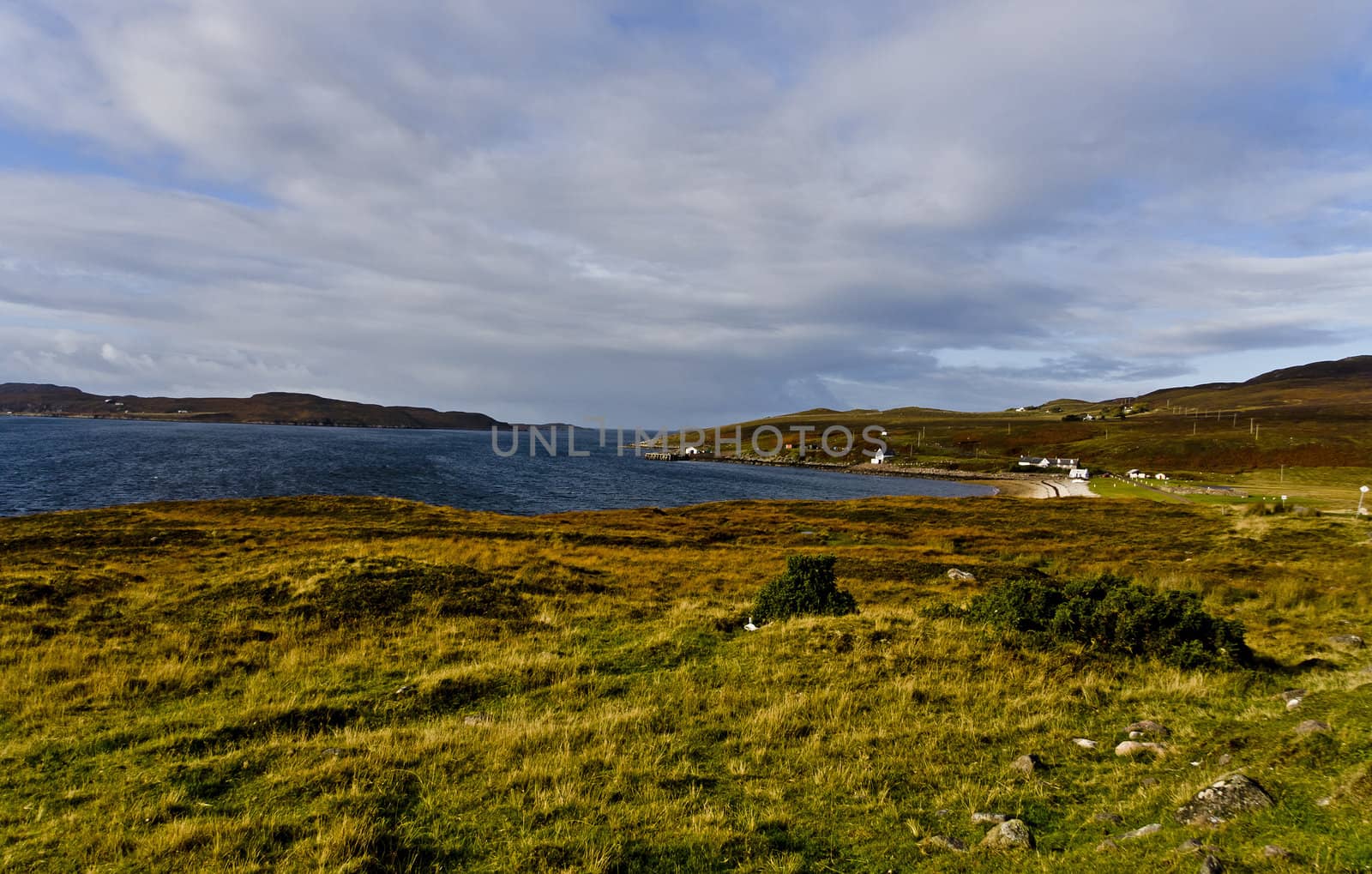 rural scottish scene at the coast with wetland and cloudy sky