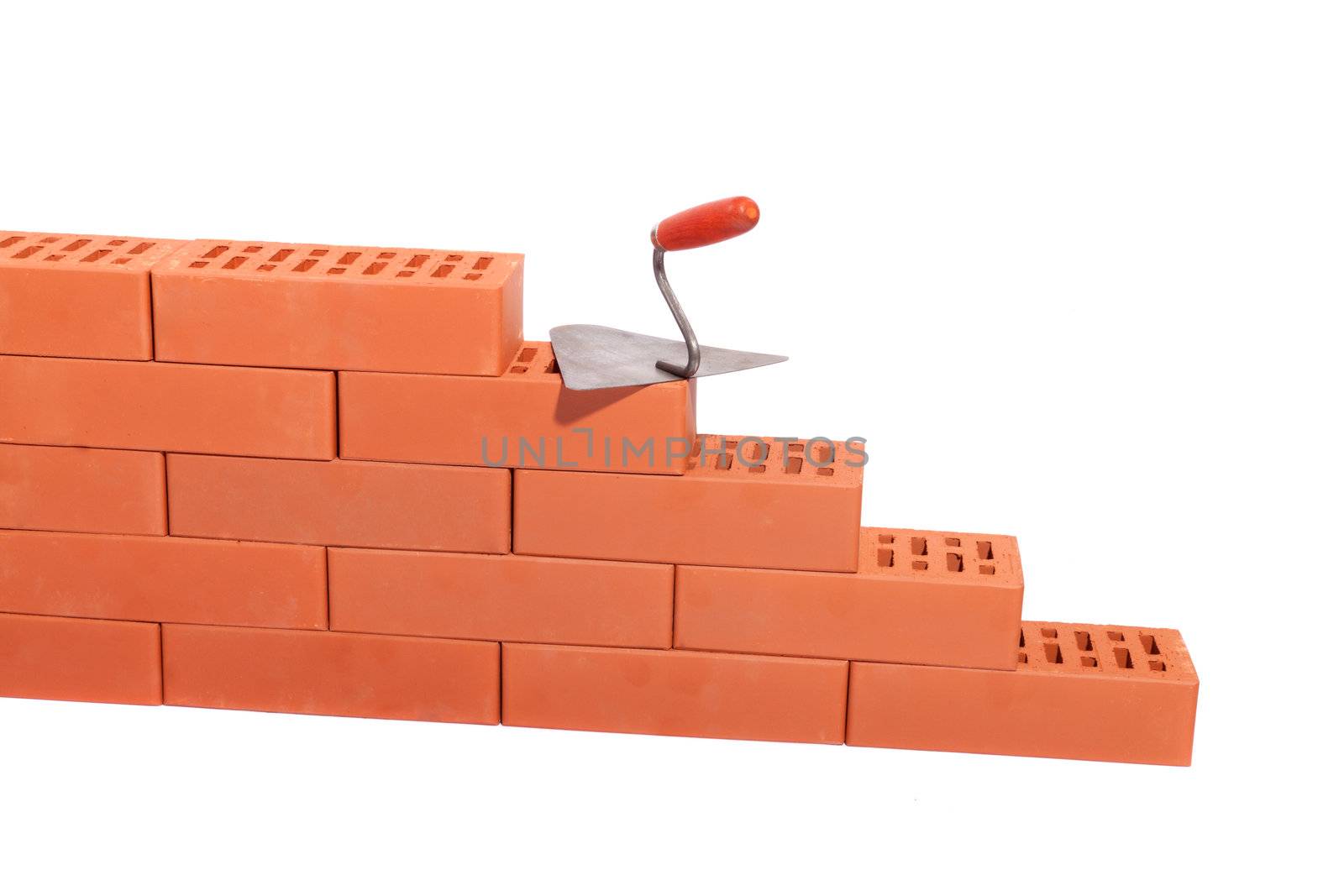 red bricks and trowel, photo on the white background