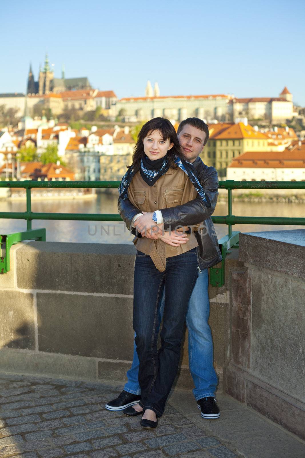 young couple on the Charles Bridge on the skyline by jannyjus