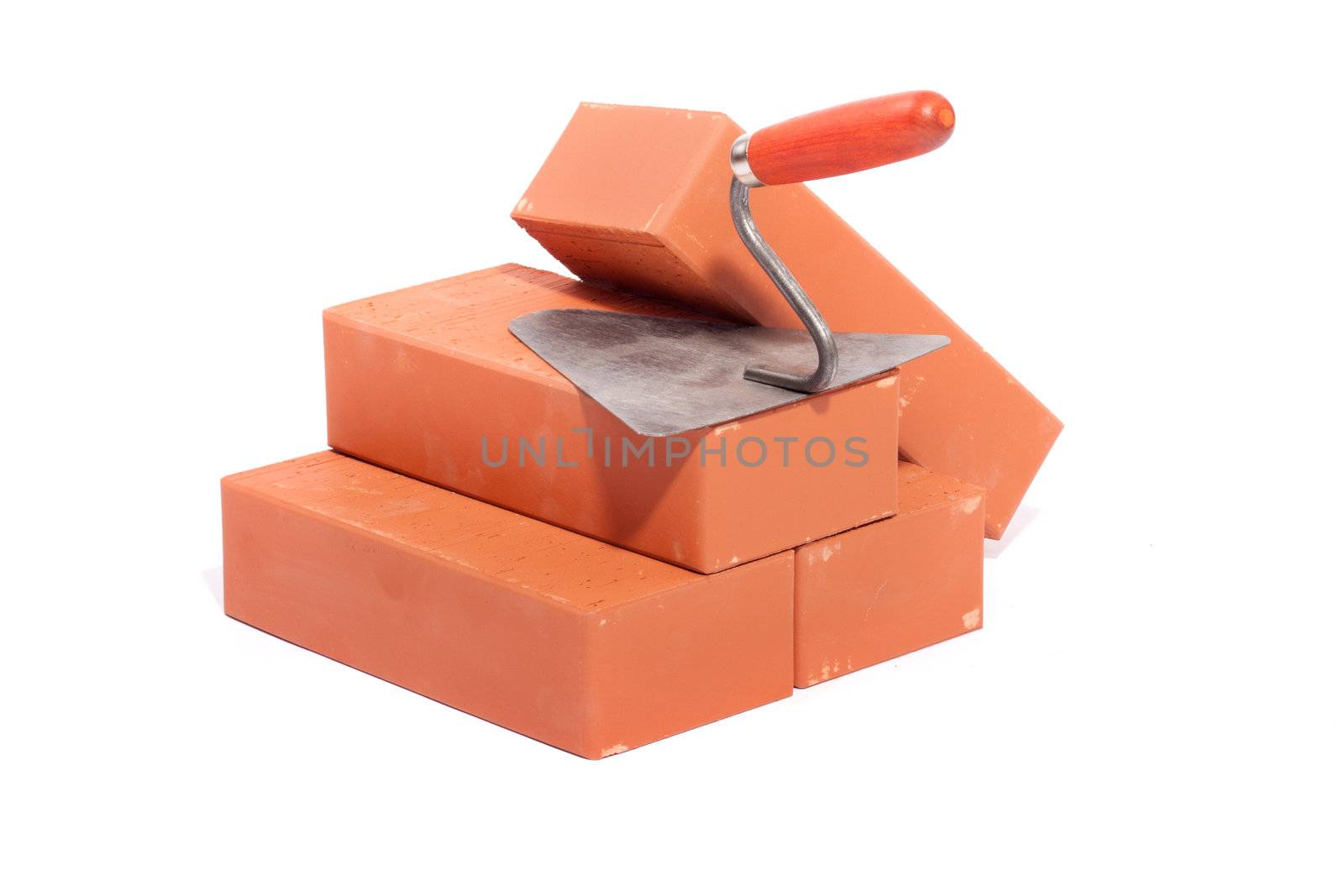 red bricks and trowel, photo on the white background