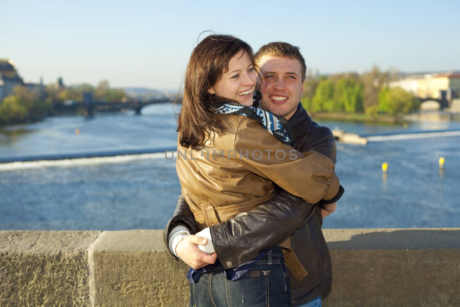 young couple on the Charles Bridge on the skyline by jannyjus