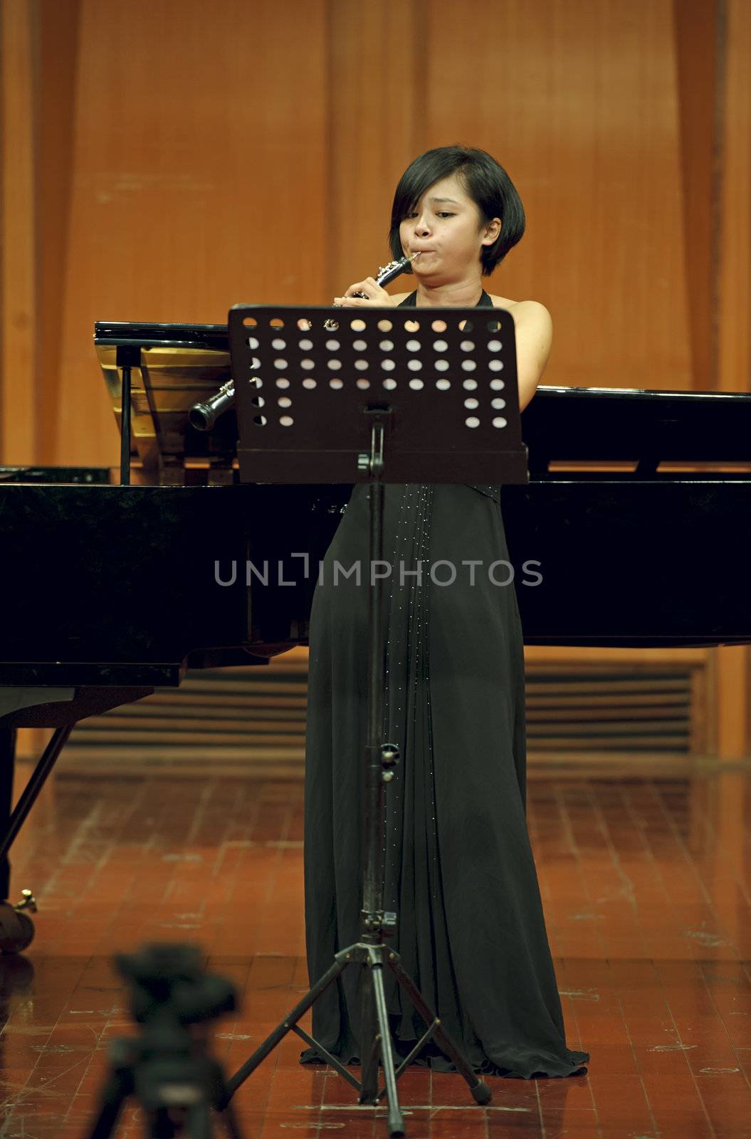 CHENGDU - JUN 20: oboist performs on wind music chamber music concert at odeum of Sichuan Conservatory of Music on Jun 20,2012 in Chengdu,China.