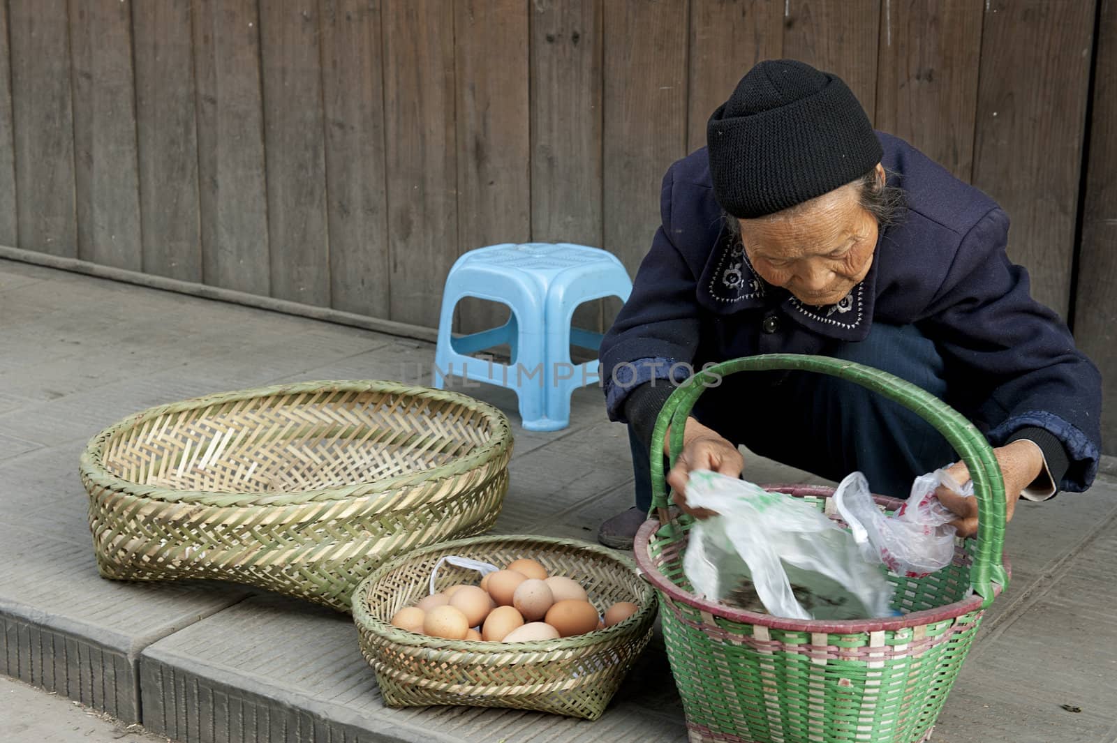 woman is selling eggs in a town by jackq