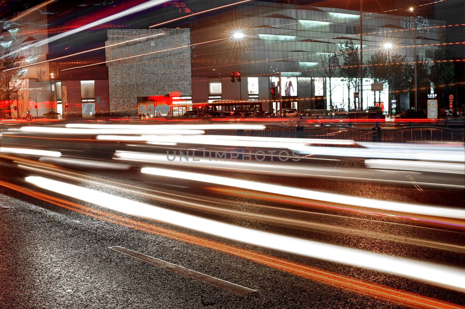 High speed and blurred cars light trails in downtown nightscape