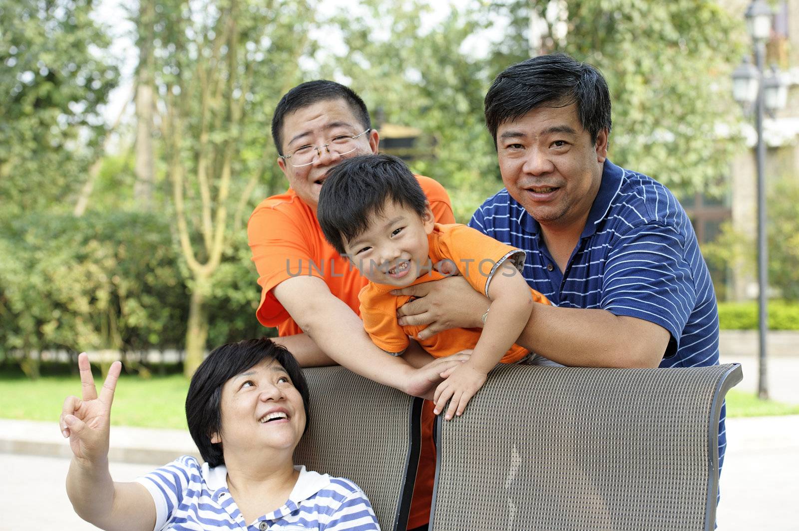 happy kid playing with his uncle and aunt