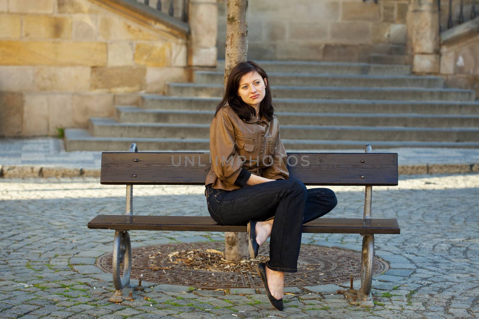 beautiful young woman sitting on a bench