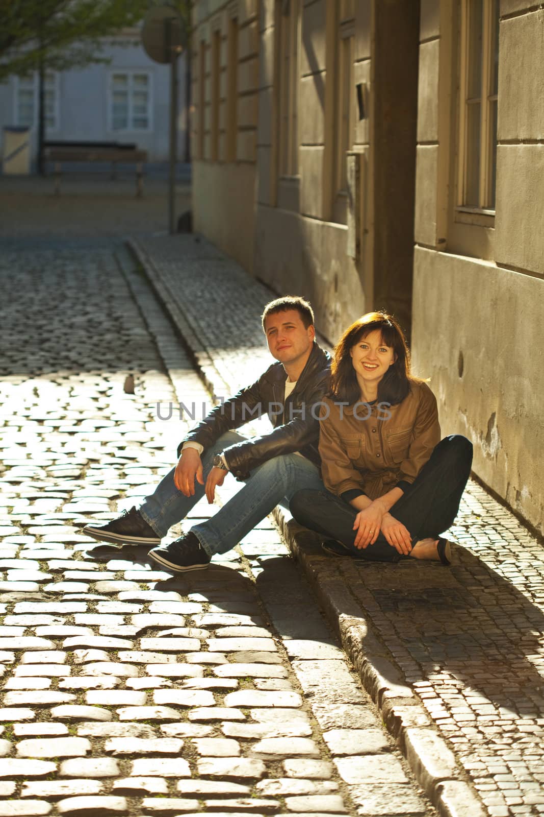 love couple sitting on the pavement by jannyjus