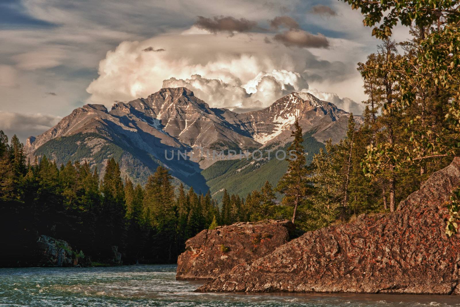 A storm gathers over the mountains at sunset in Banff - Canada. by Claudine