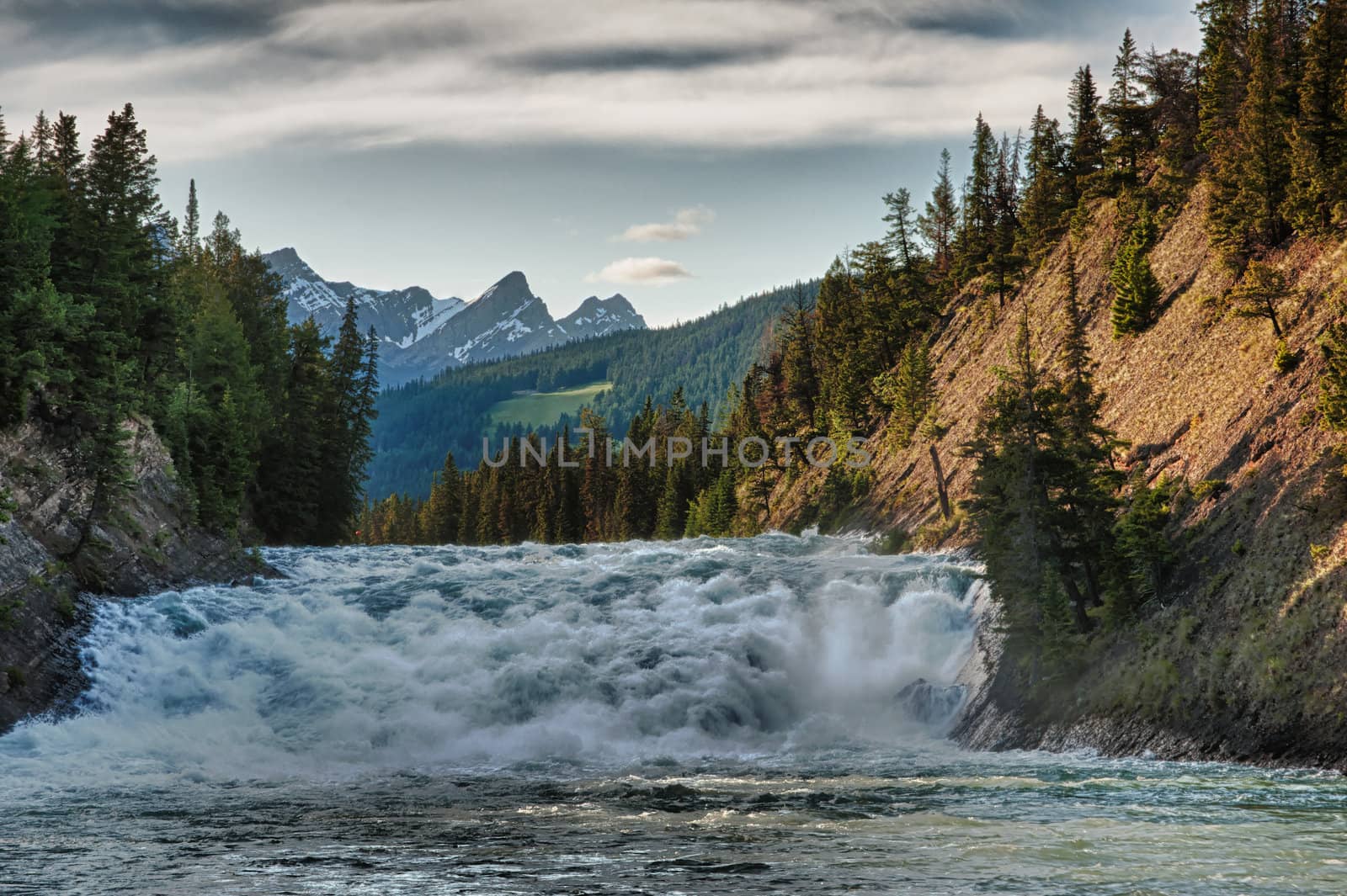 Rapid on the river during sunset near Banff in Canada. by Claudine