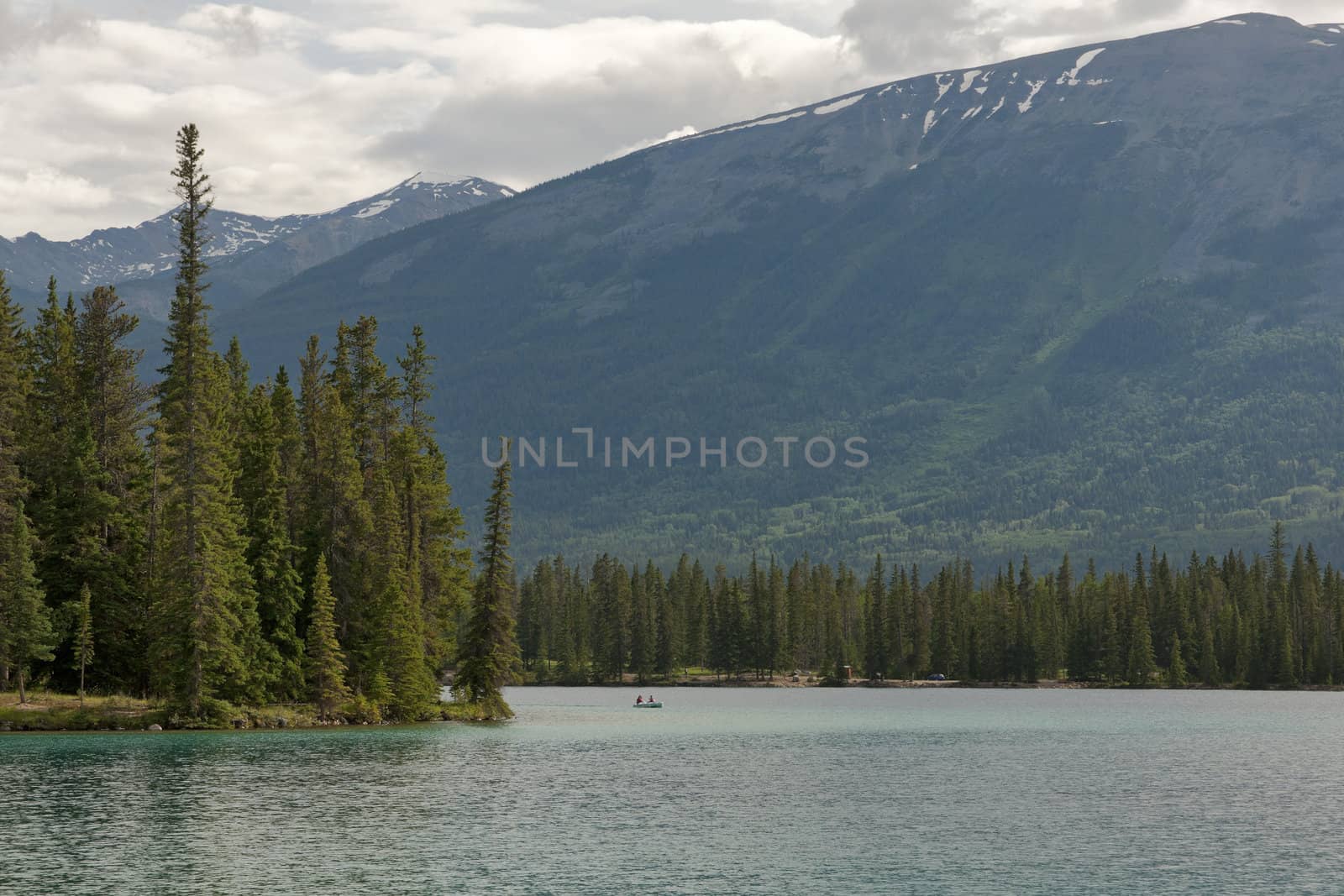 Rowing the canoe over a lake near Jasper in the Canadian Rocky M by Claudine
