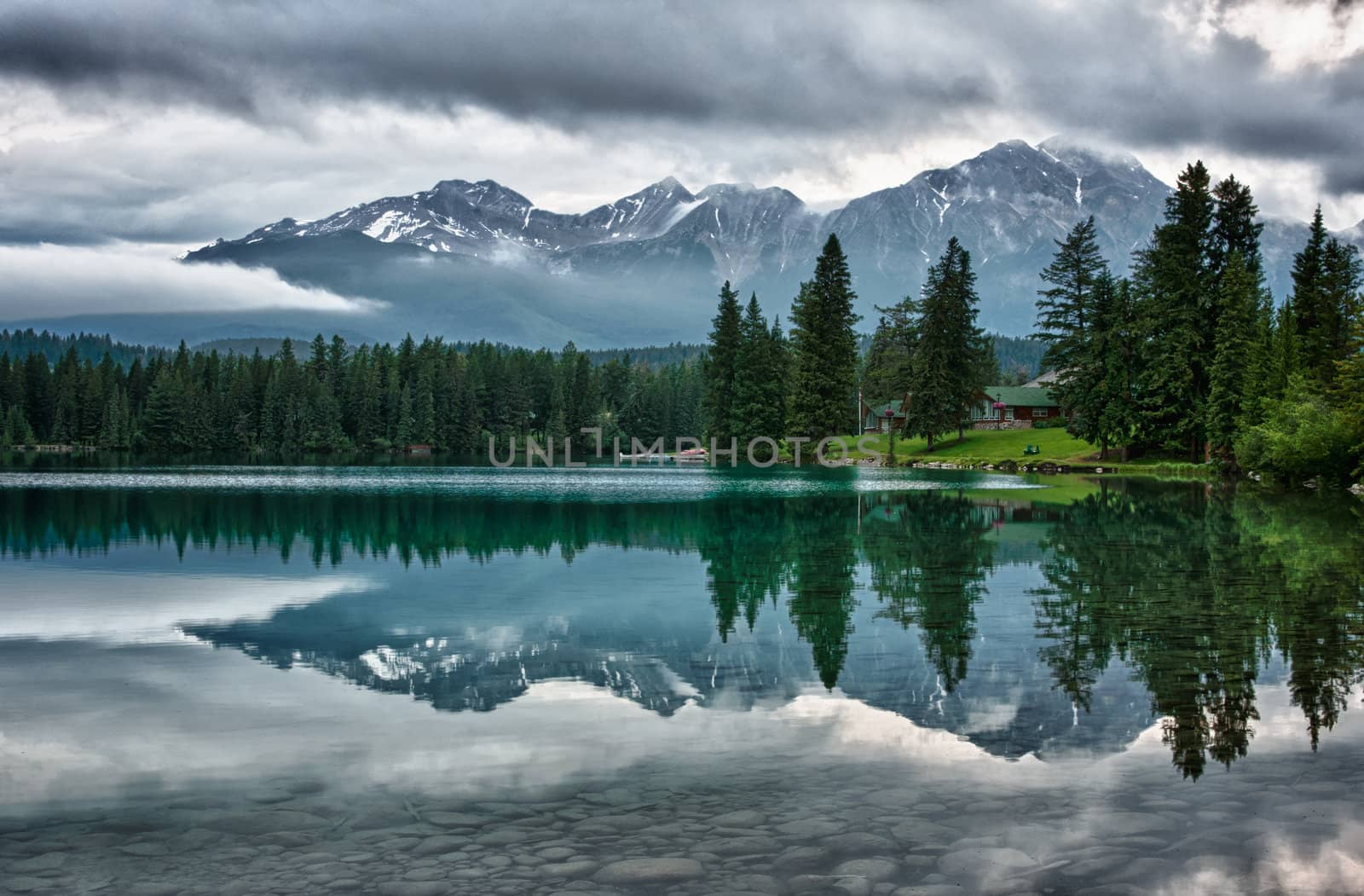 Grey cloudy skies block partially the view of the snow caps.