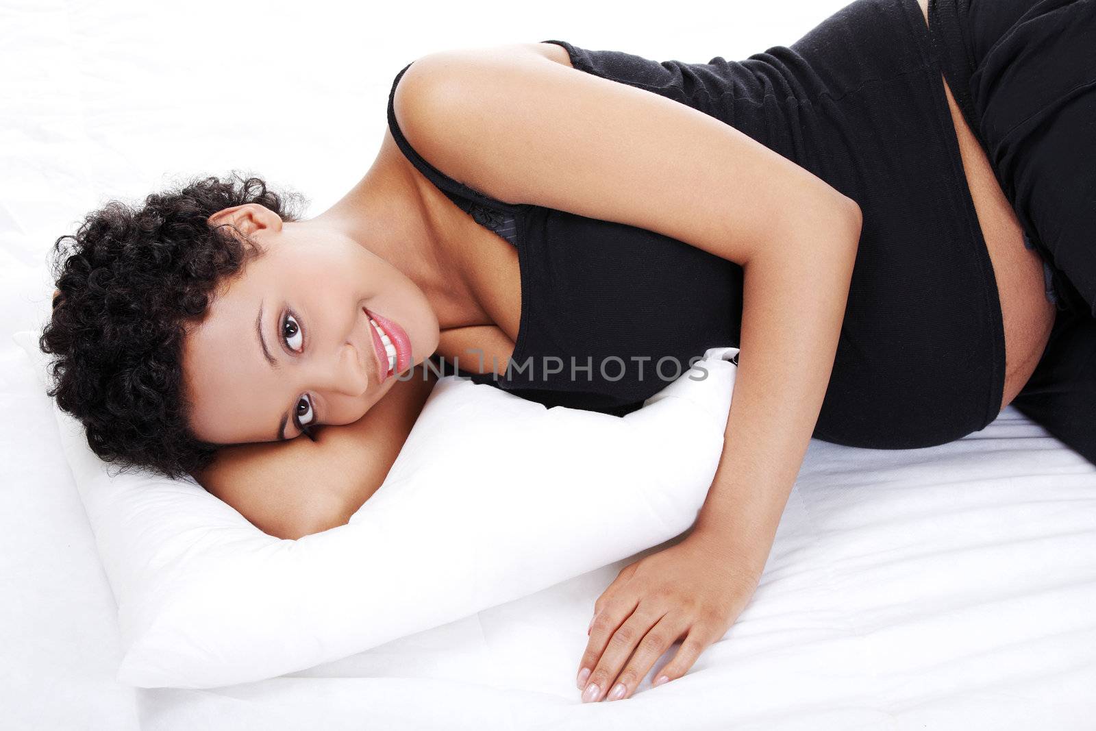 Portrait of a beautiful young pregnant woman while sleeping, isolated on a white background.