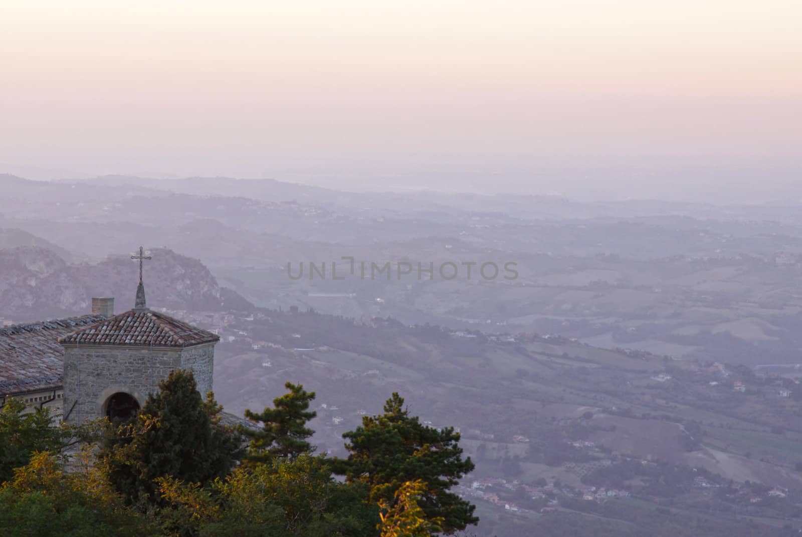 The bell tower of the Basilica of San Marino, over looking the country side at dusk. 