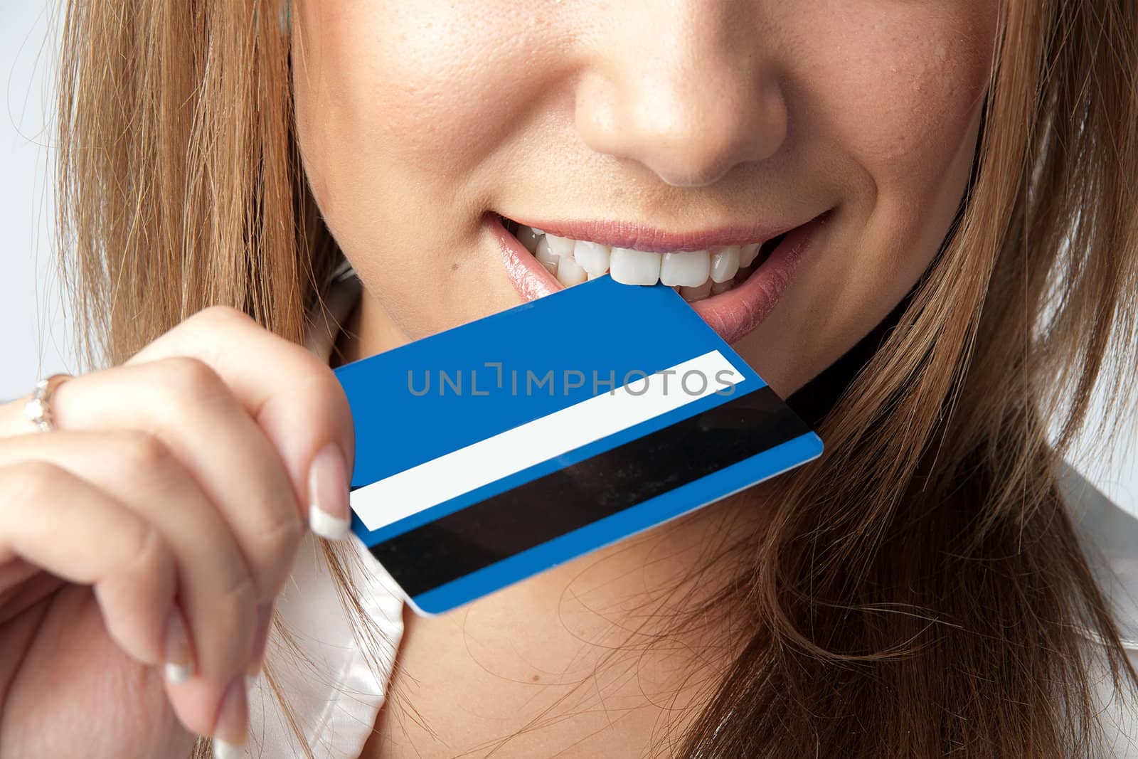 Young and beautiful girl with a credit card in the hands of blue