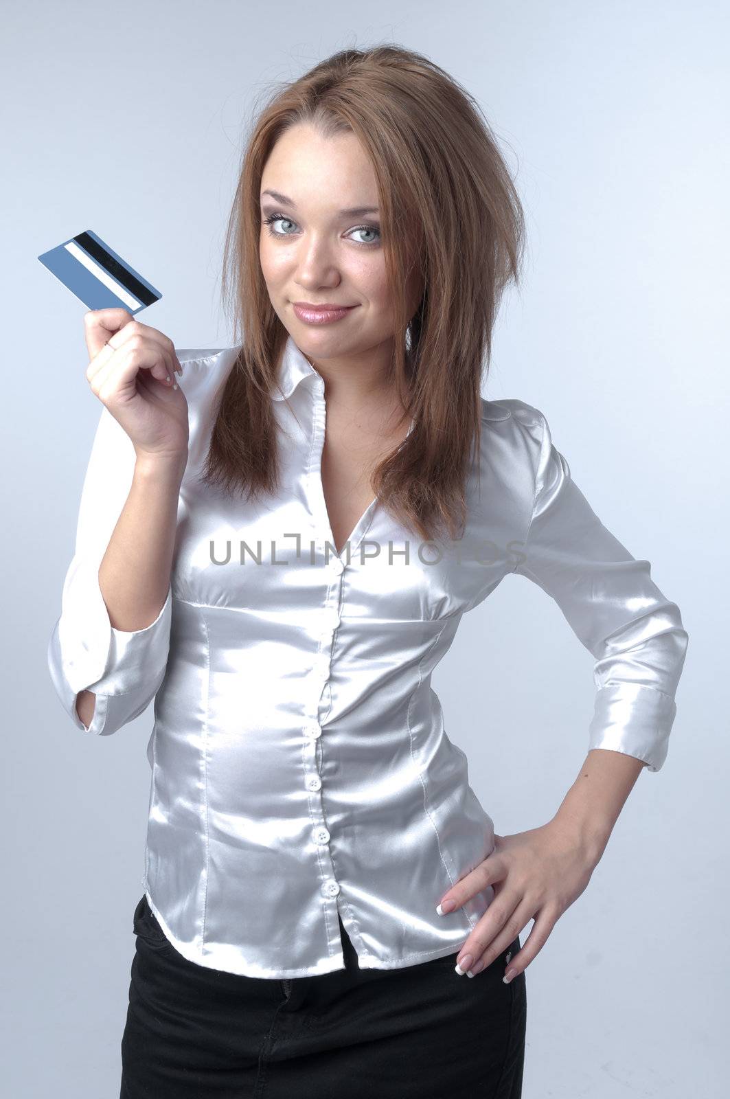 Young and beautiful girl with a credit card in the hands of blue
