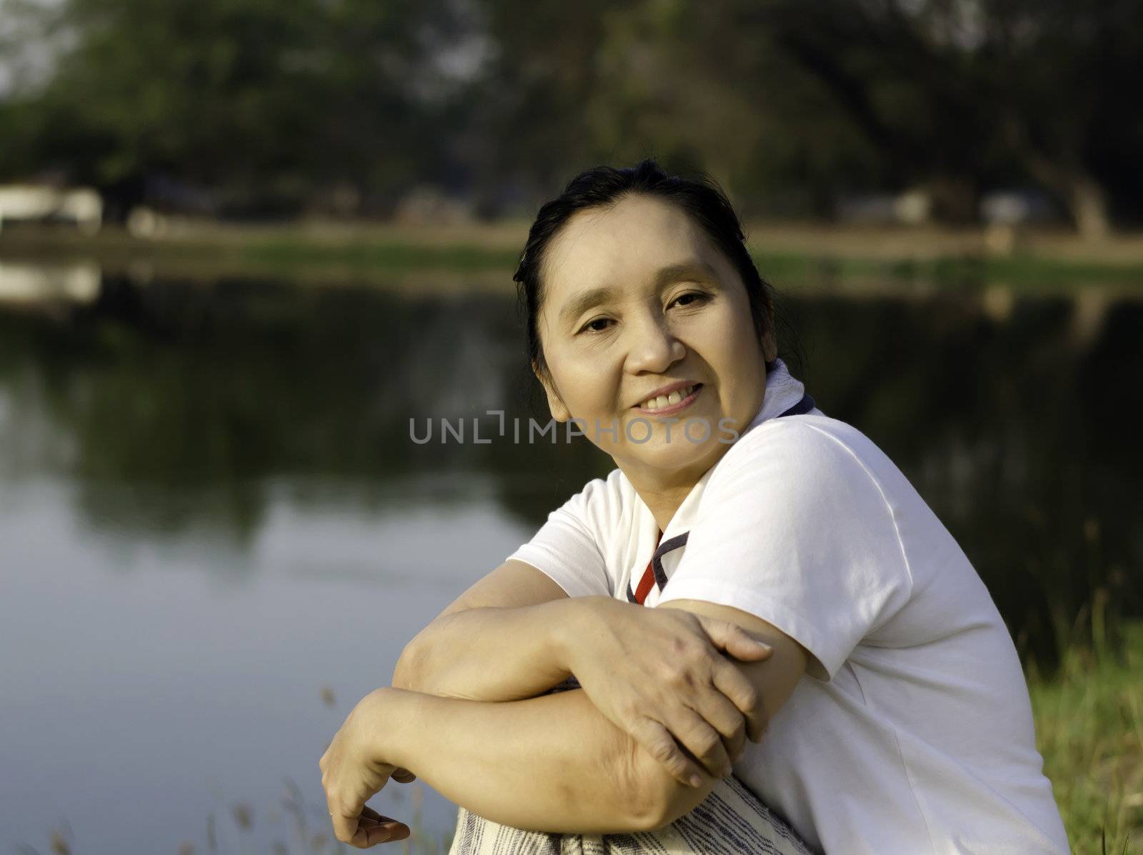 Portrait of happy asian woman in the park