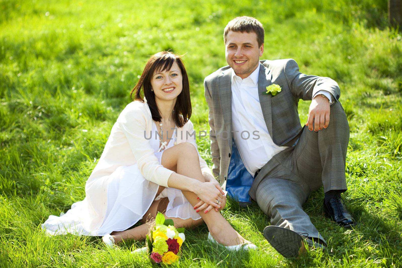  just married in a flowering garden sitting on the grass by jannyjus