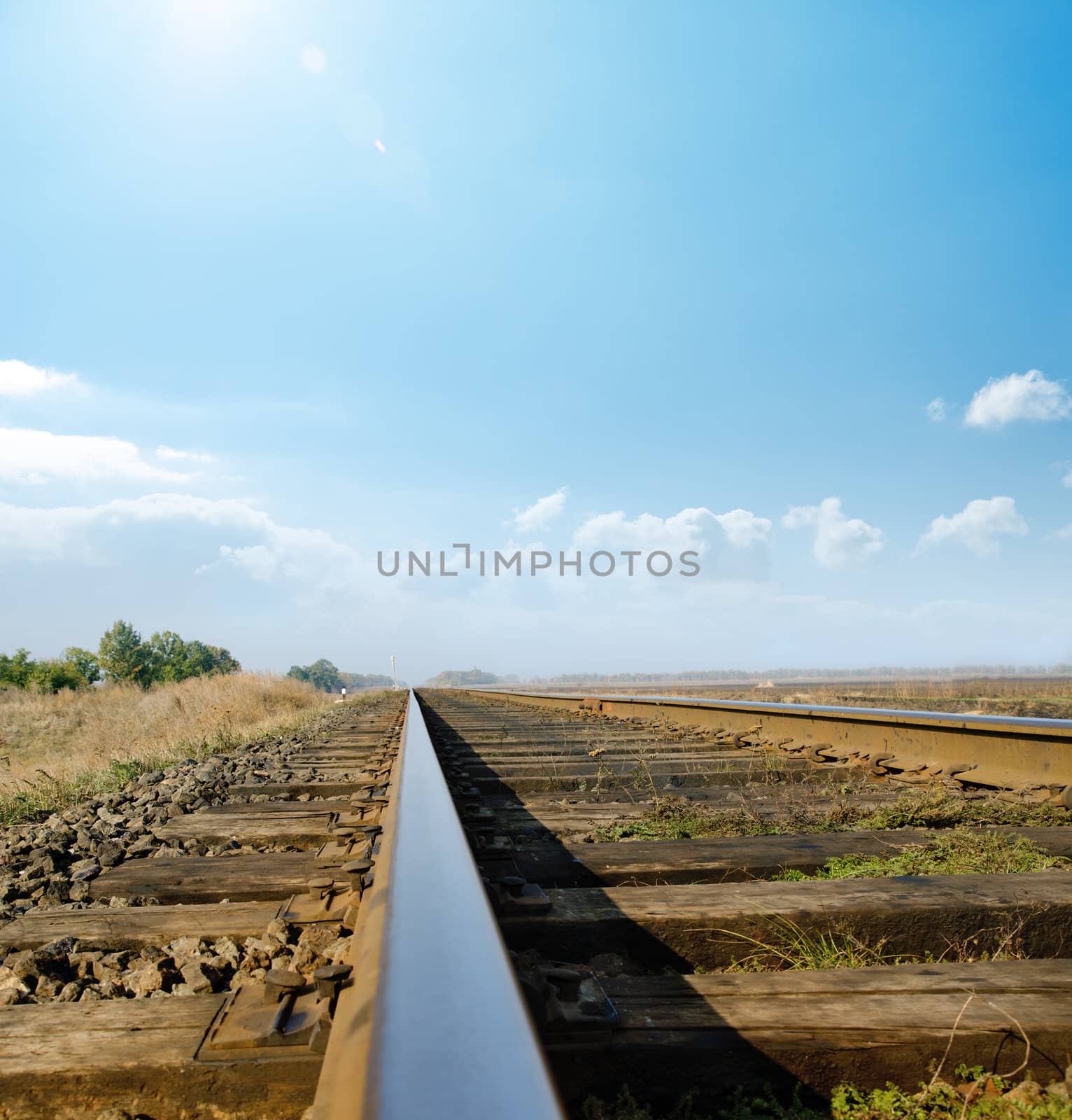 railway to horizon under sunny sky