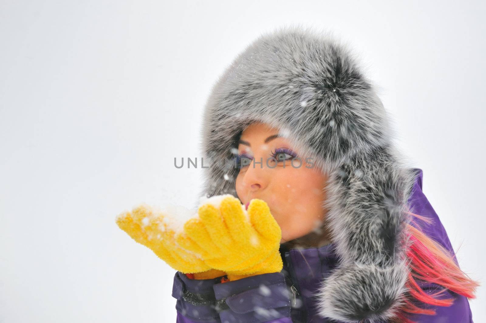 Young Beautiful Woman play in winter time