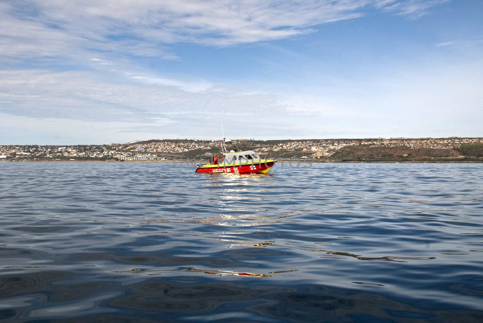 A rescue boat with a town in the background